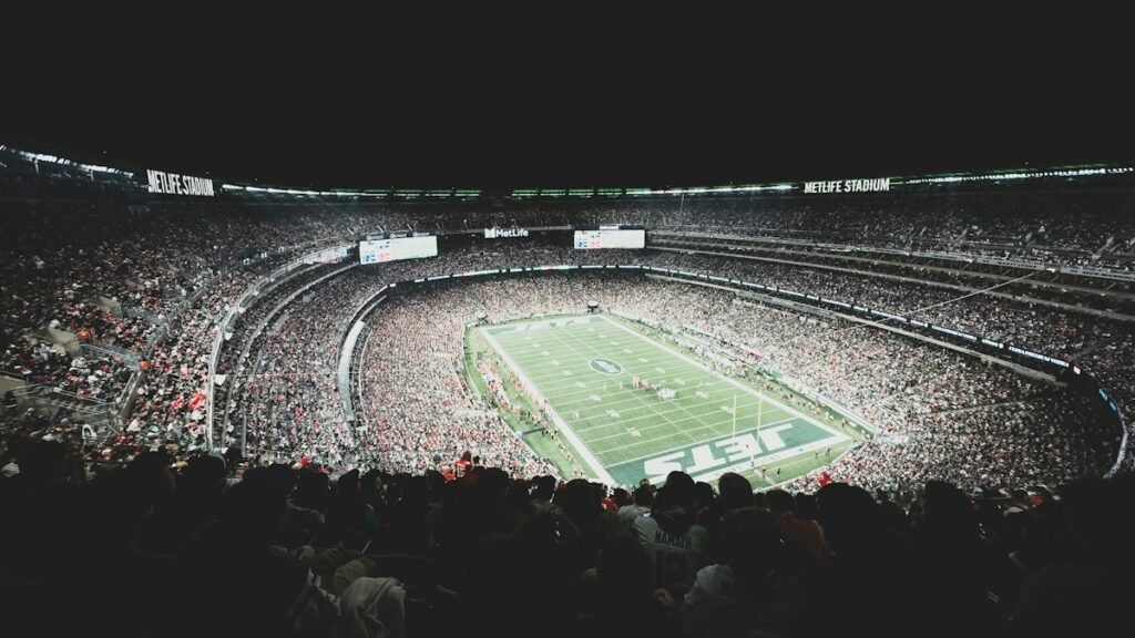 Packed stadium crowd watching a football game