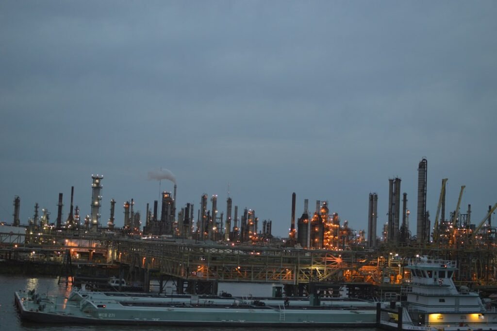 Industrial oil refinery complex at dusk, representing Russian oil and diesel sanctions