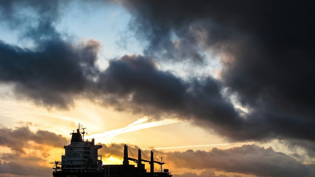 Ship sailing at sunset, a stock photo illustrating oil shipping concerns in the Trump Iran war