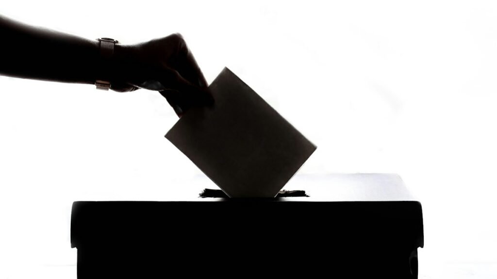Person casting a ballot into a box, a stock photo illustrating the Washington ballots dispute