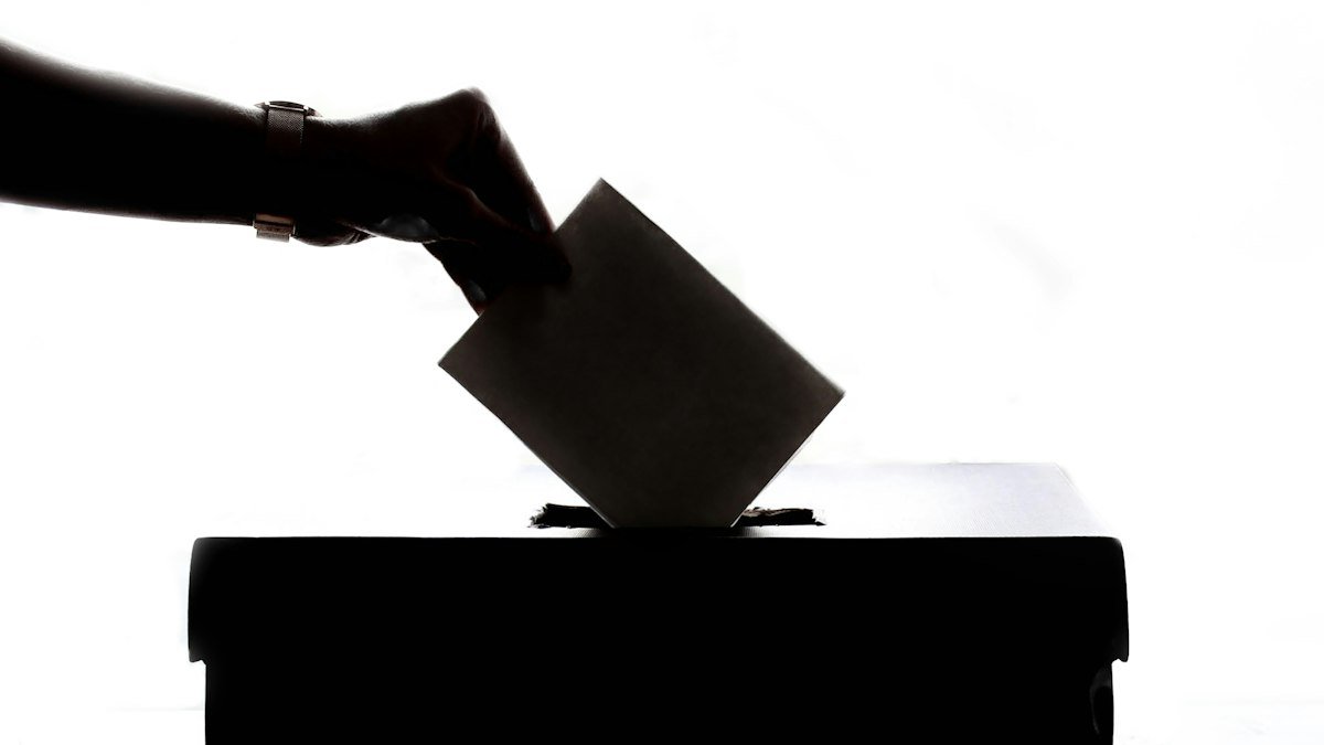 Person casting a ballot into a box, a stock photo illustrating the Washington ballots dispute